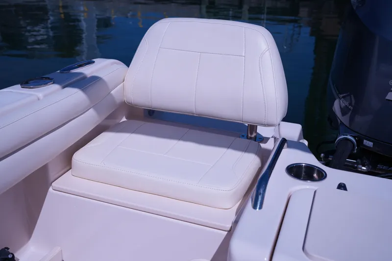 Slide: The Image of 2019 Grady-White Freedom 215 boat seat with white upholstery and cup holder. - 18