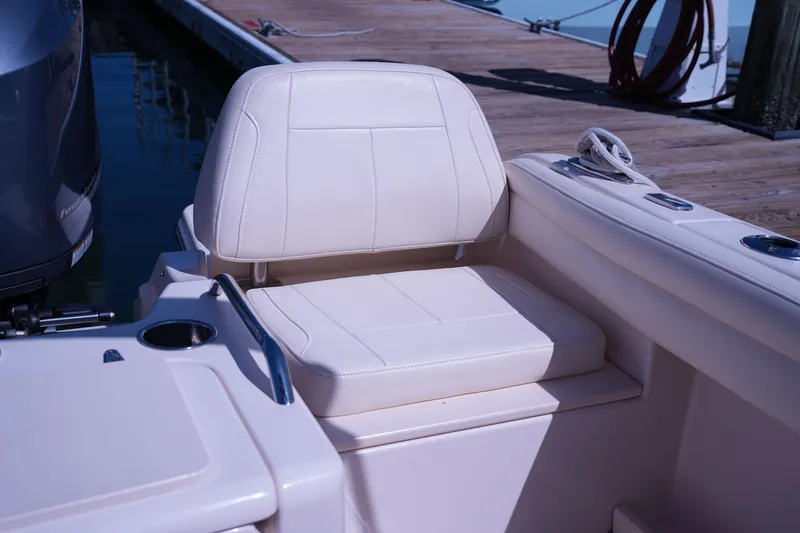 Slide: The Image of 2019 Grady-White Freedom 215 boat seat with cup holder, docked at marina. - 19