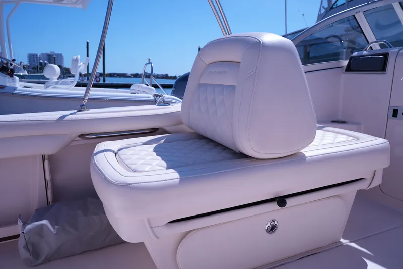 Slide: The Image of 2019 Grady-White Freedom 215 boat interior with white cushioned seating. - 23