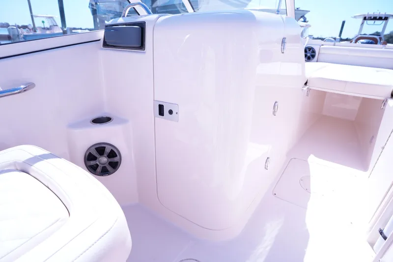 Slide: The Image of 2019 Grady-White Freedom 215 boat interior with storage compartments and seating. - 24