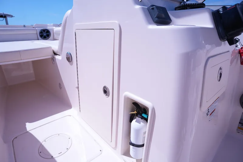 Slide: The Image of 2019 Grady-White Freedom 215 boat interior with storage compartments and fire extinguisher. - 28