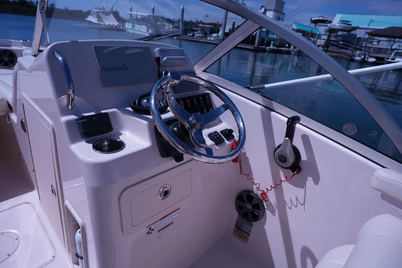 Slide: The Image of 2019 Grady-White Freedom 215 boat cockpit with steering wheel and Garmin navigation system. - 32