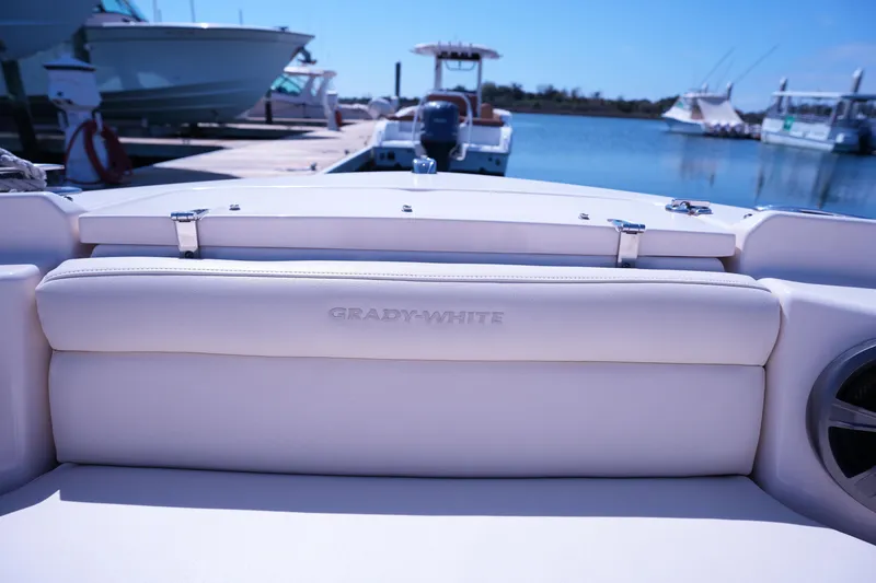 Slide: The Image of 2019 Grady-White Freedom 215 boat interior at marina, showcasing luxury seating. - 43