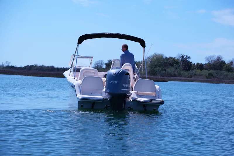 Slide: The Image of 2019 Grady-White Freedom 215 boat on calm water, rear view with outboard motor. - 5