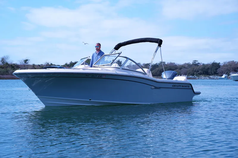 Slide: The Image of 2019 Grady-White Freedom 215 boat on calm water with a person onboard. - 7