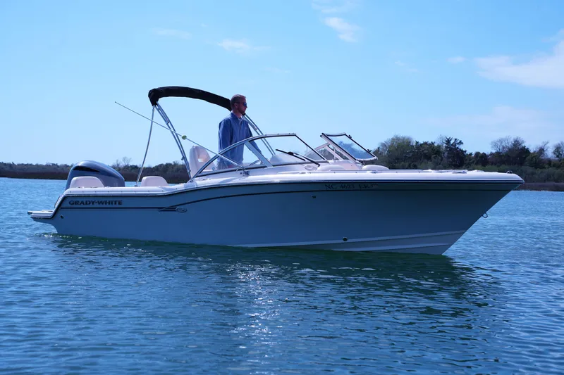 Slide: The Image of 2019 Grady-White Freedom 215 boat on calm water under clear sky. - 9