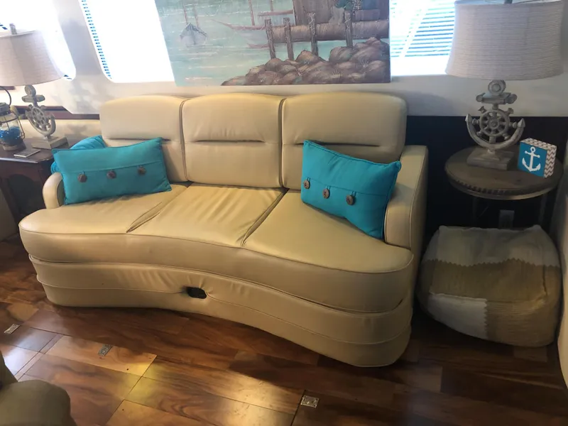 Slide: The Image of Beige leather sofa with blue pillows in a 1990 Bluewater Sedan. - 19