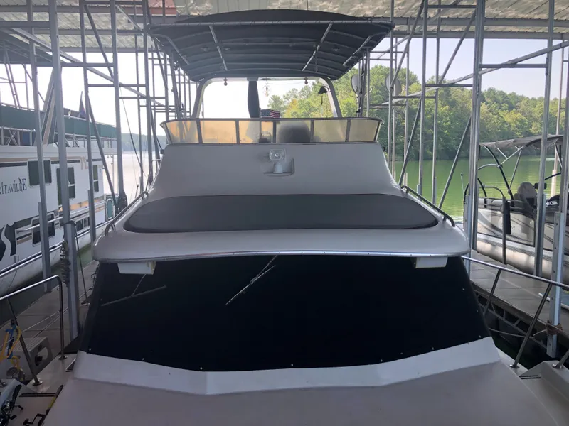 Slide: The Image of 1990 Bluewater Sedan boat docked in a covered marina. - 2