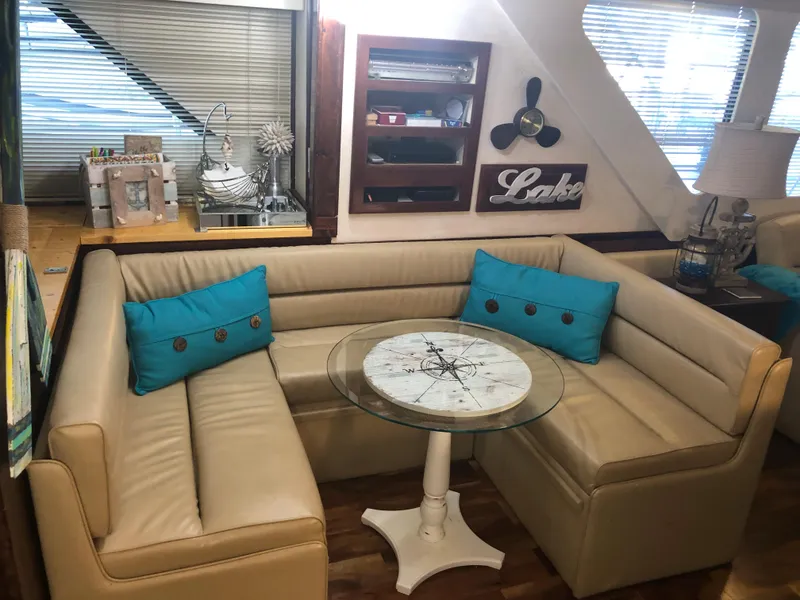 Slide: The Image of 1990 Bluewater Sedan interior with beige leather seating and nautical decor. - 24