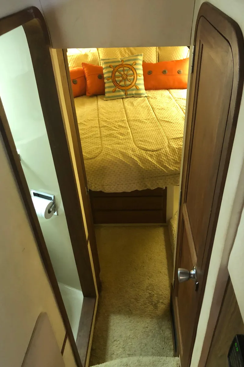 Slide: The Image of 1990 Bluewater Sedan bedroom with cozy bed and nautical decor. - 26