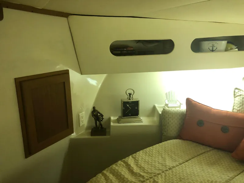 Slide: The Image of 1990 Bluewater Sedan interior cabin with bed, shelves, and nautical decor. - 28