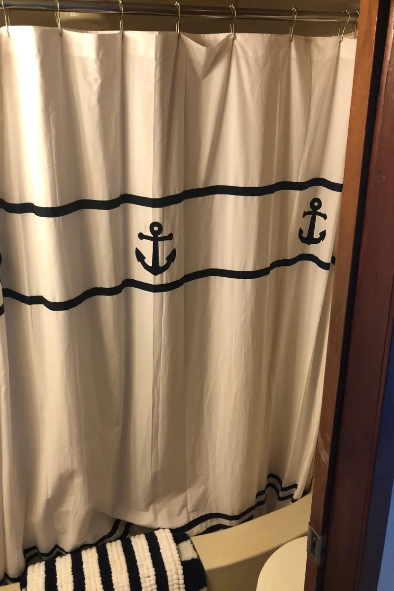 Slide: The Image of Nautical-themed bathroom with anchor shower curtain in a 1990 Bluewater Sedan. - 37