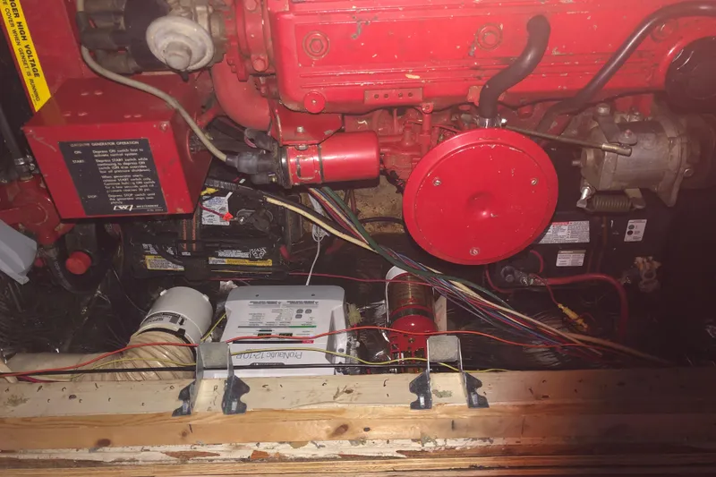 Slide: The Image of Engine compartment of a 1990 Bluewater Sedan with visible wiring and components. - 45