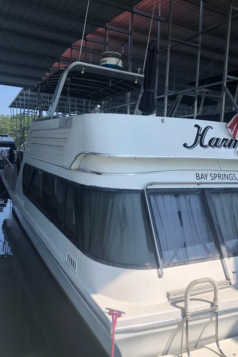 Slide: The Image of 1990 Bluewater Sedan yacht docked at marina. - 5