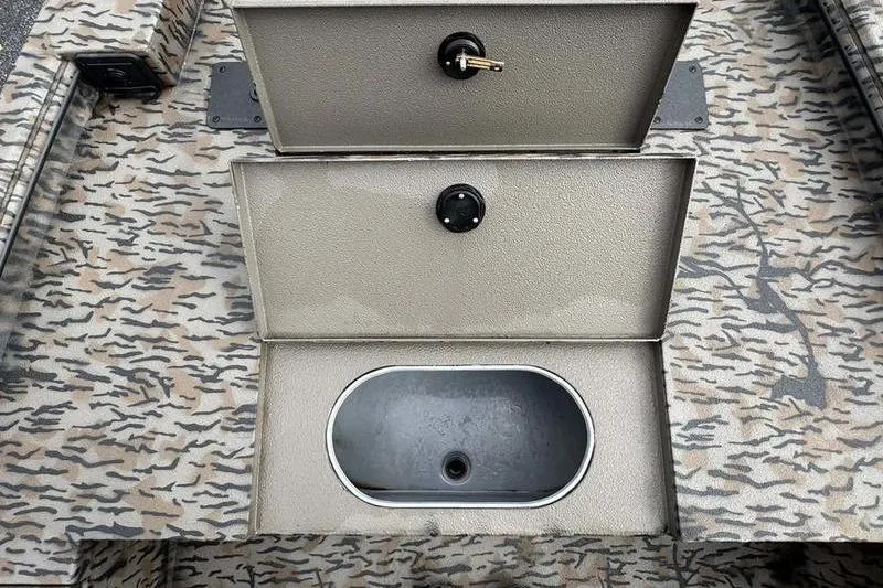 Slide: The Image of 2026 Xpress X18DB boat interior with camo pattern and storage compartments. - 11