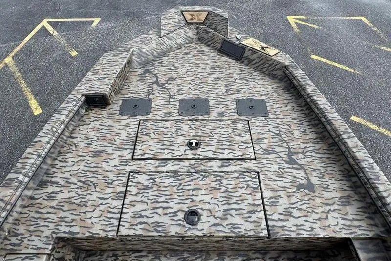 Slide: The Image of 2026 Xpress X18DB boat deck with camouflage pattern and storage compartments. - 12