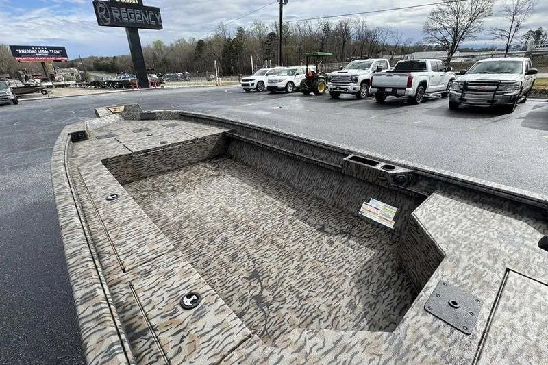 Slide: The Image of 2026 Xpress X18DB boat with camouflage design in a dealership parking lot. - 15