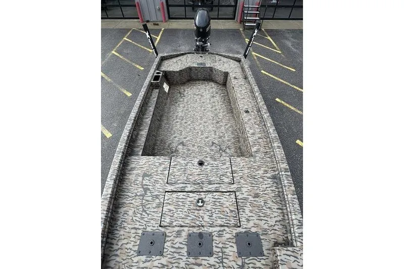 Slide: The Image of 2026 Xpress X18DB boat with camouflage design, parked in a lot. - 19