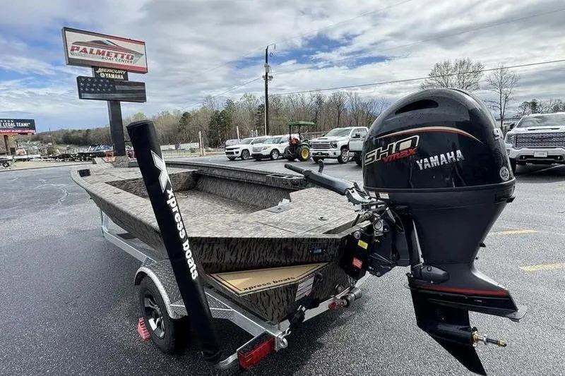 Slide: The Image of 2026 Xpress X18DB boat with Yamaha engine on trailer in dealership lot. - 4
