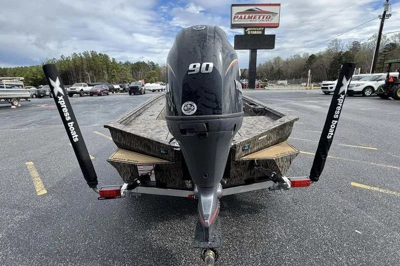 Slide: The Image of 2026 Xpress X18DB boat with 90 HP engine on trailer in parking lot. - 5