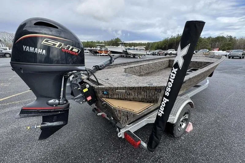 Slide: The Image of 2026 Xpress X18DB boat with Yamaha engine on trailer in parking lot. - 7