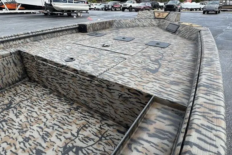 Slide: The Image of 2026 Xpress X18DB boat with camouflage pattern, parked in a lot. - 8