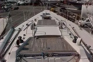 Slide: The Image of 1986 Fast Masthead Sloop with bowthruster, docked in a marina, showcasing deck and rigging. - 13