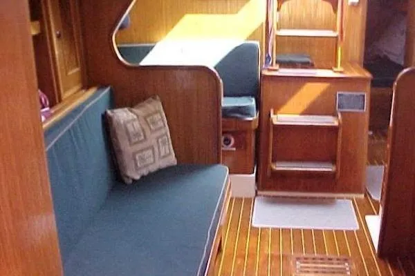 Slide: The Image of Interior of 1986 Fast Masthead Sloop with wooden finish and blue seating. - 17