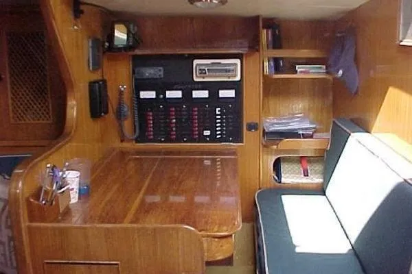 Slide: The Image of Interior of 1986 Fast Masthead Sloop with wooden table and seating area. - 20