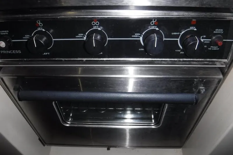 Slide: The Image of Stainless steel oven with control knobs, labeled "Princess," in a 1986 Fast Masthead Sloop. - 6