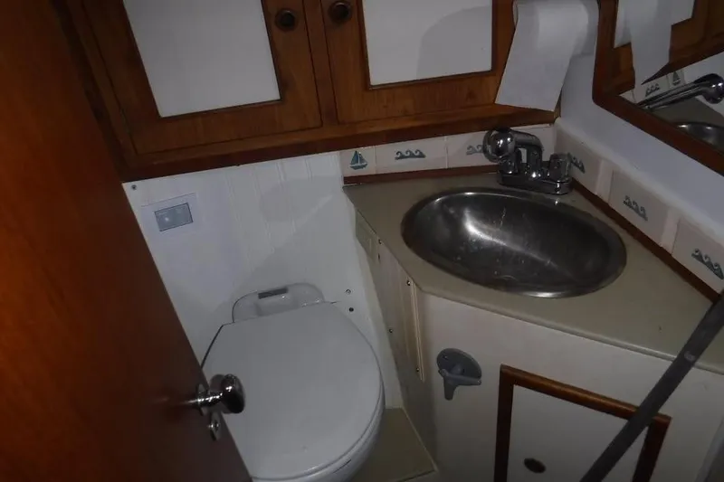 Slide: The Image of Compact bathroom in 1986 Fast Masthead Sloop with sink and toilet. - 8