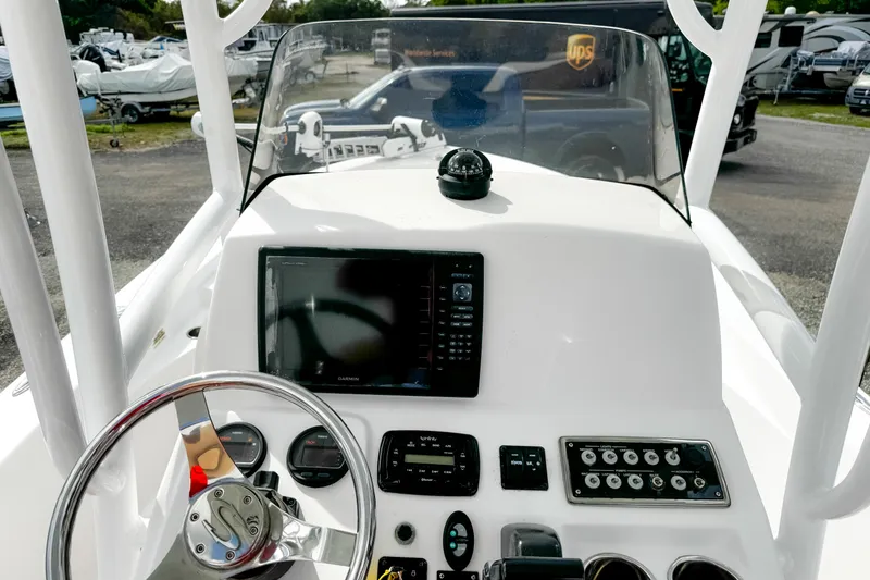 Slide: The Image of 2014 Sportsman Masters 247 Bay Boat dashboard with navigation equipment and steering wheel. - 11