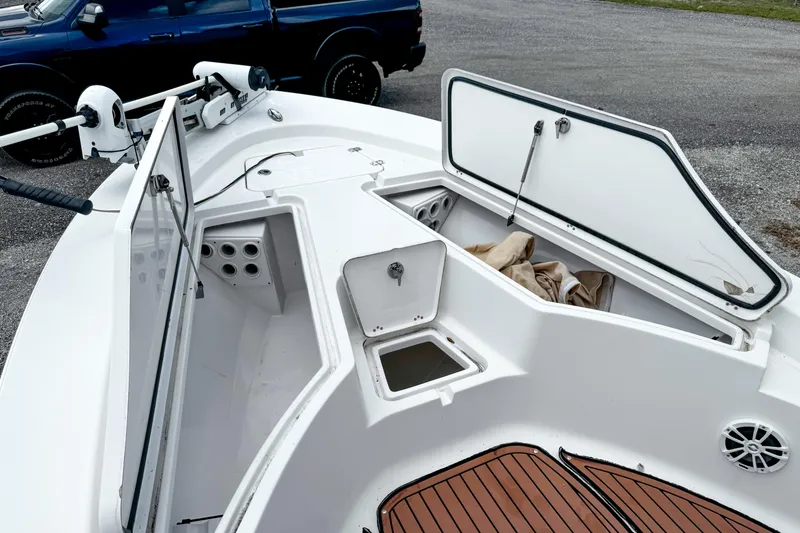 Slide: The Image of 2014 Sportsman Masters 247 Bay Boat with open storage compartments and trolling motor. - 17