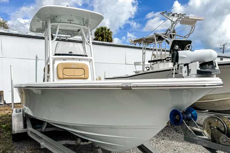 Slide: The Image of 2014 Sportsman Masters 247 Bay Boat on trailer, parked outdoors under a cloudy sky. - 2