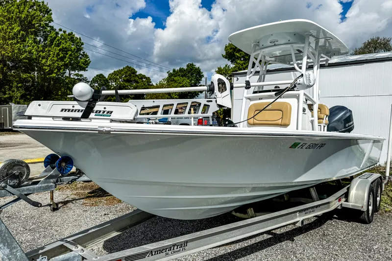 Slide: The Image of 2014 Sportsman Masters 247 Bay Boat on trailer, parked outdoors under cloudy sky. - 22