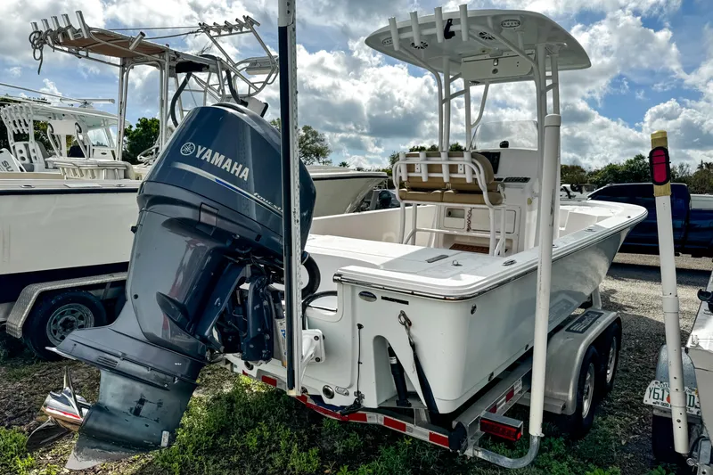 Slide: The Image of 2014 Sportsman Masters 247 Bay Boat with Yamaha engine on trailer, parked outdoors. - 4
