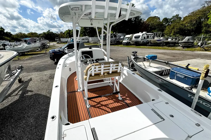 Slide: The Image of 2014 Sportsman Masters 247 Bay Boat with T-top and wooden deck, parked outdoors. - 7