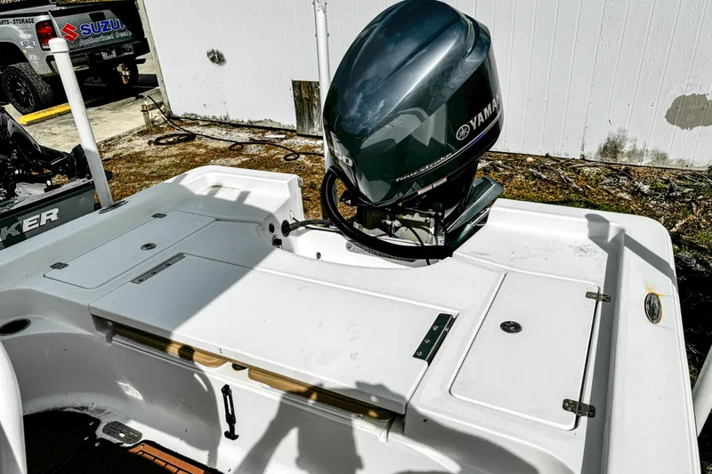 Slide: The Image of 2014 Sportsman Masters 247 Bay Boat with Yamaha outboard motor in a yard setting. - 8