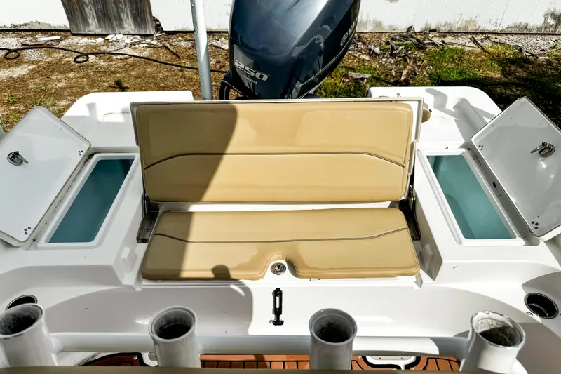 Slide: The Image of 2014 Sportsman Masters 247 Bay Boat with tan seating and storage compartments. - 9