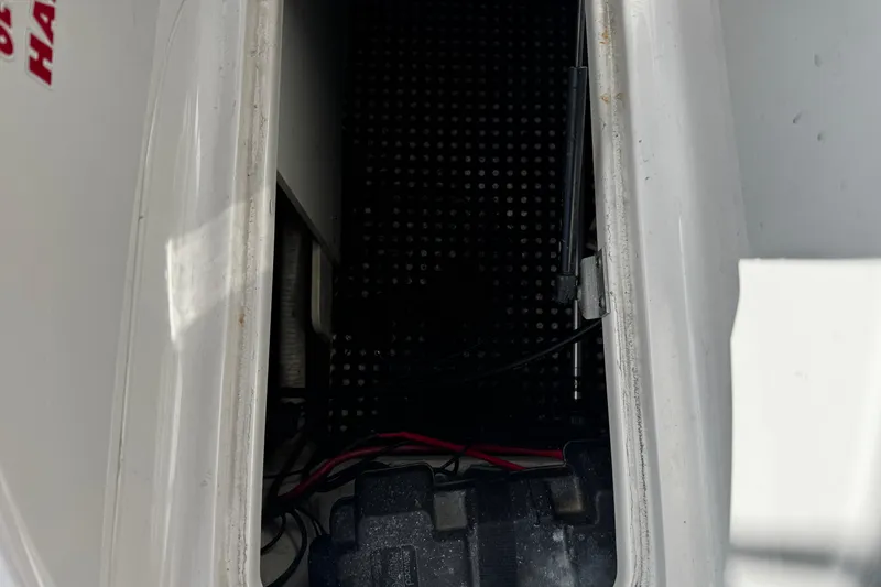 Slide: The Image of Storage compartment of a 2004 Four Winns 205 Sundowner boat, showing interior details. - 13