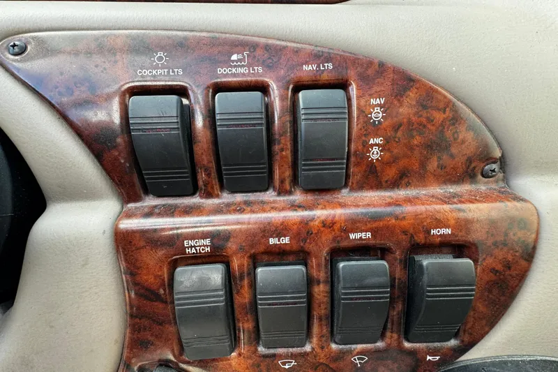 Slide: The Image of Control panel of a 2004 Four Winns 205 Sundowner boat with various switches. - 19