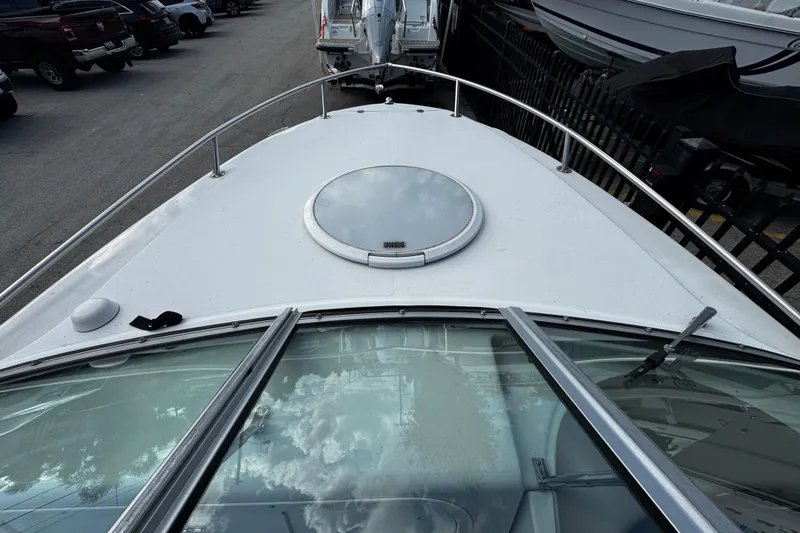 Slide: The Image of 2004 Four Winns 205 Sundowner boat deck with hatch, parked in marina. - 5