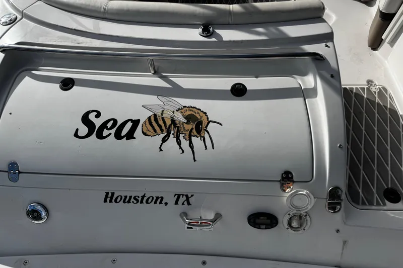Slide: The Image of 2004 Four Winns 205 Sundowner boat with bee graphic, "Sea" text, Houston, TX. - 8