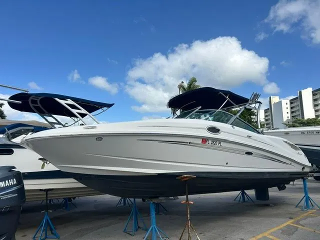 The Image of 2011 Sea Ray 300 Sundeck boat on stands, blue sky background. - 0