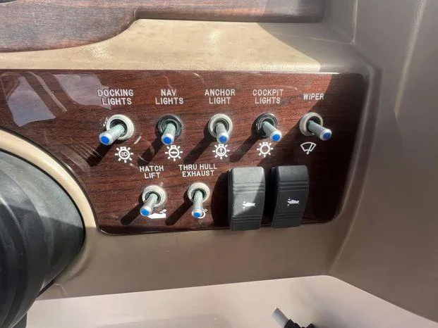 Slide: The Image of Control panel of a 2011 Sea Ray 300 Sundeck with various switches and labels. - 12