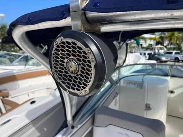 Slide: The Image of Speaker on a 2011 Sea Ray 300 Sundeck boat, featuring a blue canopy. - 15