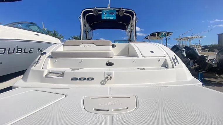 Slide: The Image of 2011 Sea Ray 300 Sundeck boat with spacious deck and seating, under clear blue sky. - 3