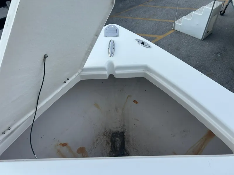Slide: The Image of Open storage compartment on 2009 Cobia 216 Center Console boat. - 10