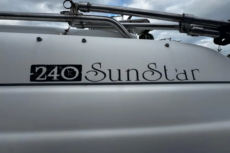 Slide: The Image of 2008 Splendor 240 SunStar boat nameplate with cloudy sky background. - 16