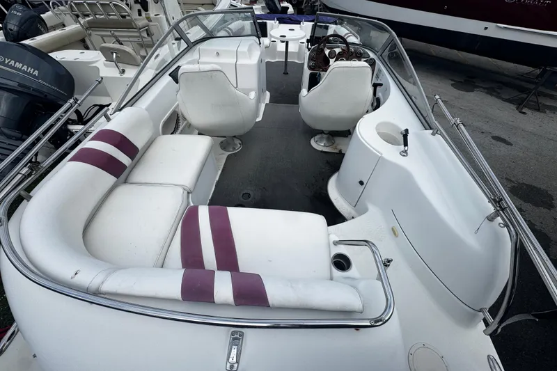 Slide: The Image of 2008 Splendor 240 Sunstar boat interior with white seating and steering console. - 3